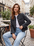 A model showcases a women's tailored autumn jacket with frayed edges, styled against a neutral background, exuding sophistication and effortless style.