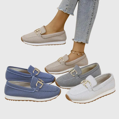 View of elegant women's loafers in soft beige fabric, featuring a breathable design and subtle stitching accents