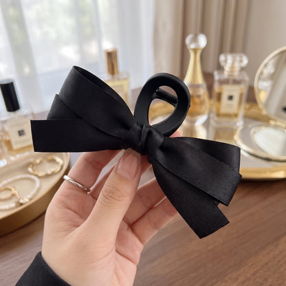 Back view of a model showing the Womens Hair Clips, showing their sophisticated design and construction details against a soft, neutral background.