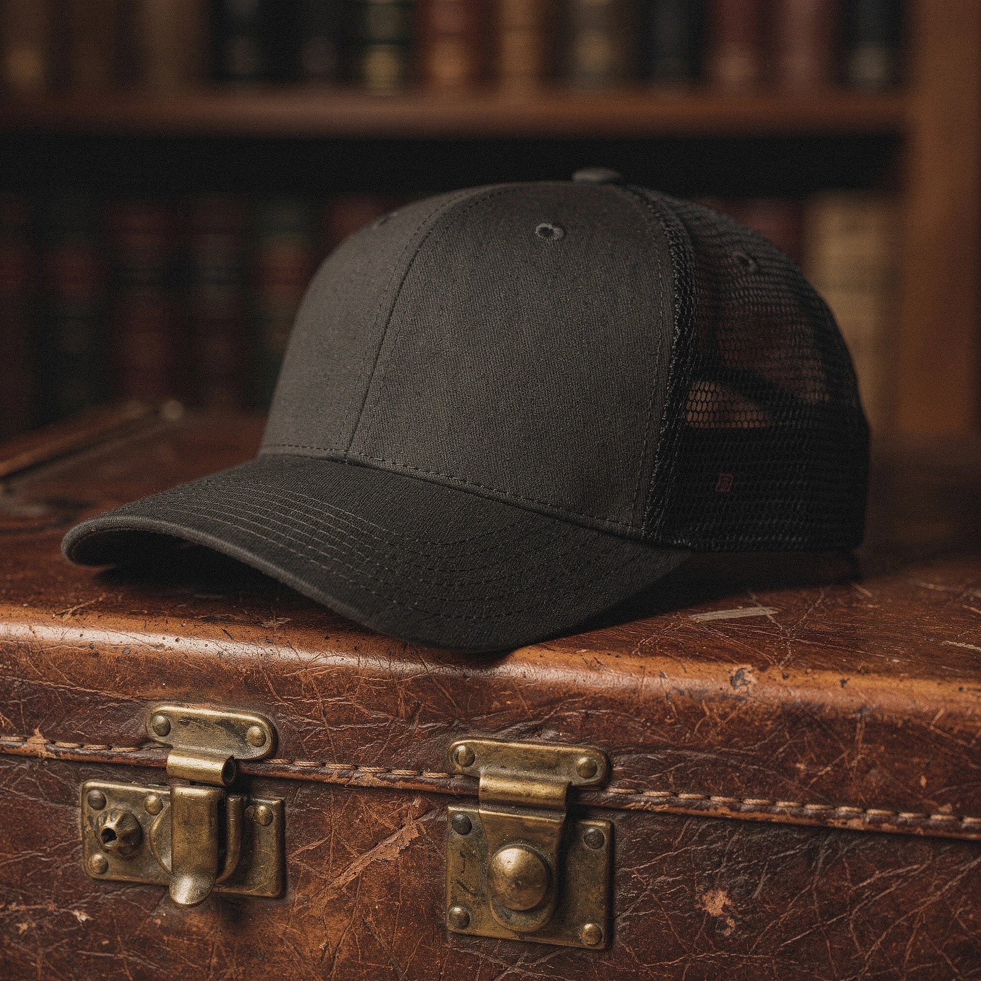 View of a relaxed vintage snapback cap in dark gray fabric, featuring a curved brim and adjustable strap