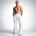 View of wide loose relaxed fit trousers in light gray fabric, featuring a comfortable waistband and pockets
