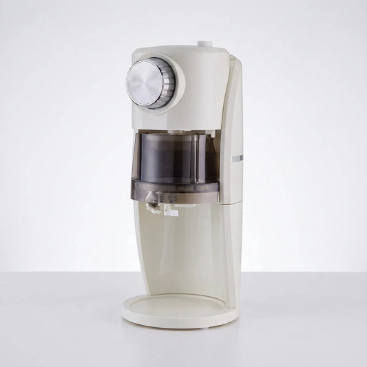 View of the compact ice shaver revealing the power cord, ventilation slits, and a sturdy base design