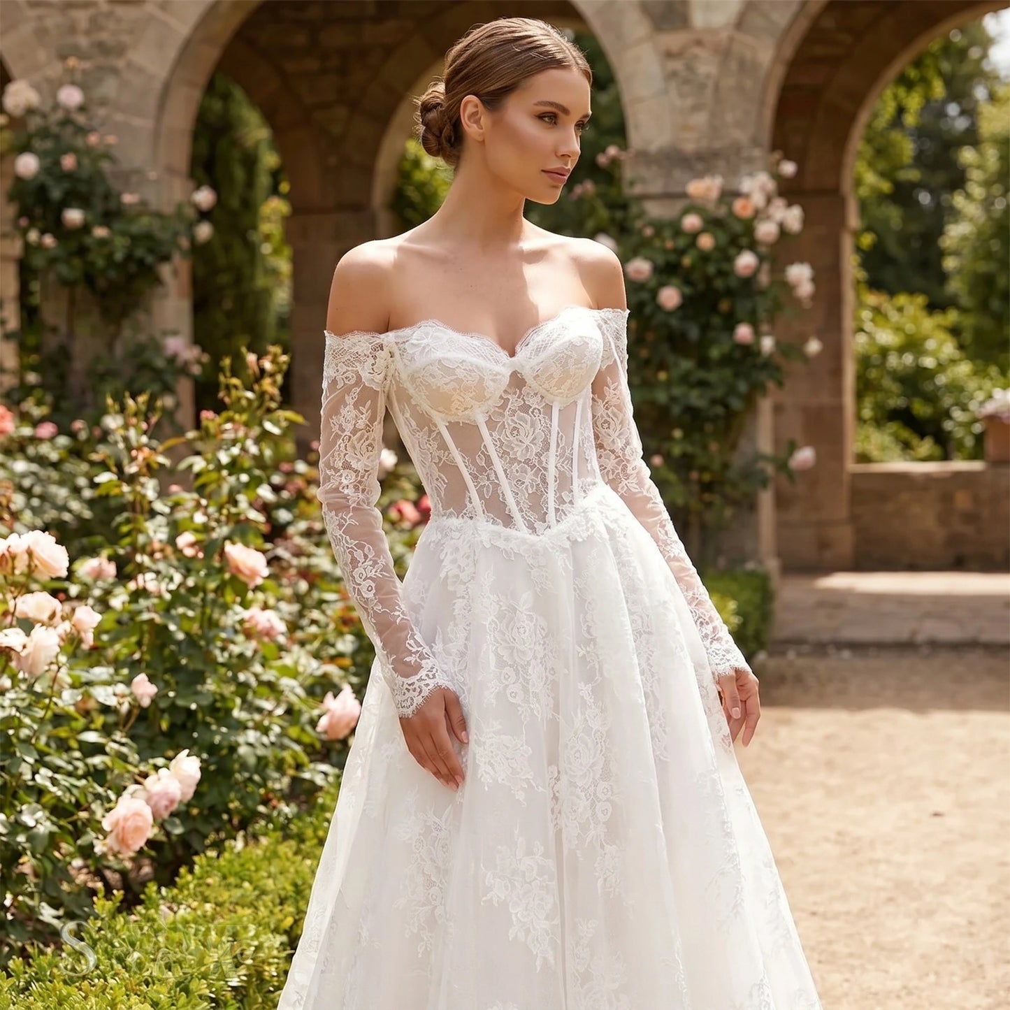 A model showcases the Womens Timeless Wedding Dress in a soft ivory hue, showing a fitted bodice and flowing skirt against a serene outdoor backdrop.