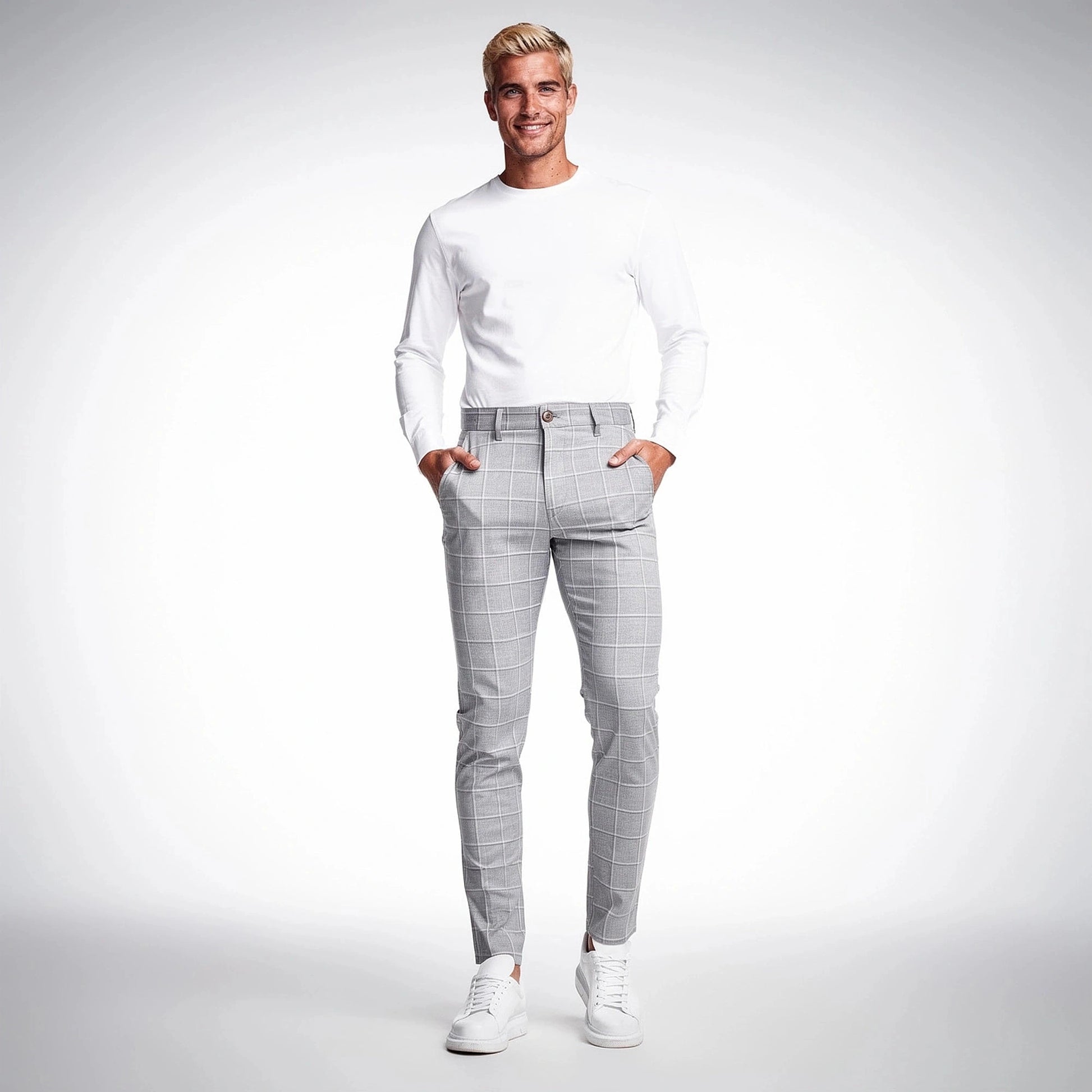 View of tailored tapered trousers in charcoal gray fabric, featuring a smooth finish and subtle pleats