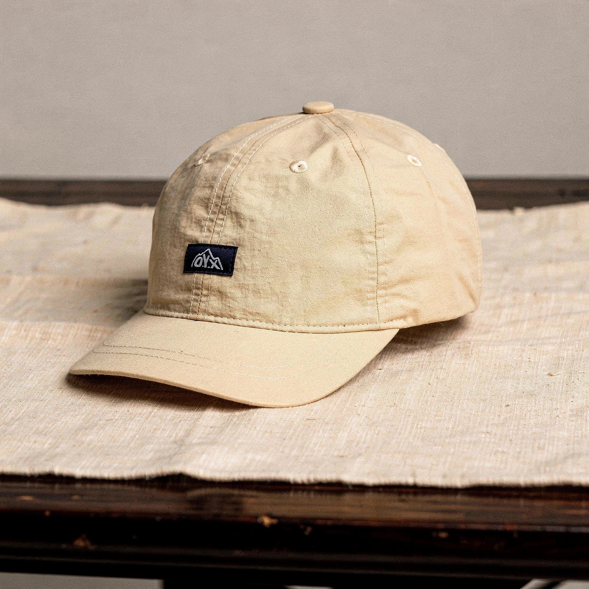 View of a stylish black baseball cap made from breathable fabric, featuring a curved brim and adjustable strap
