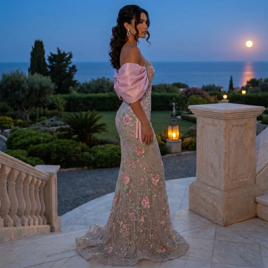 Back view of a model showing the Womens Sparkly Evening Gown in shimmering silver, showing intricate construction details and a flattering silhouette against a soft, neutral background.