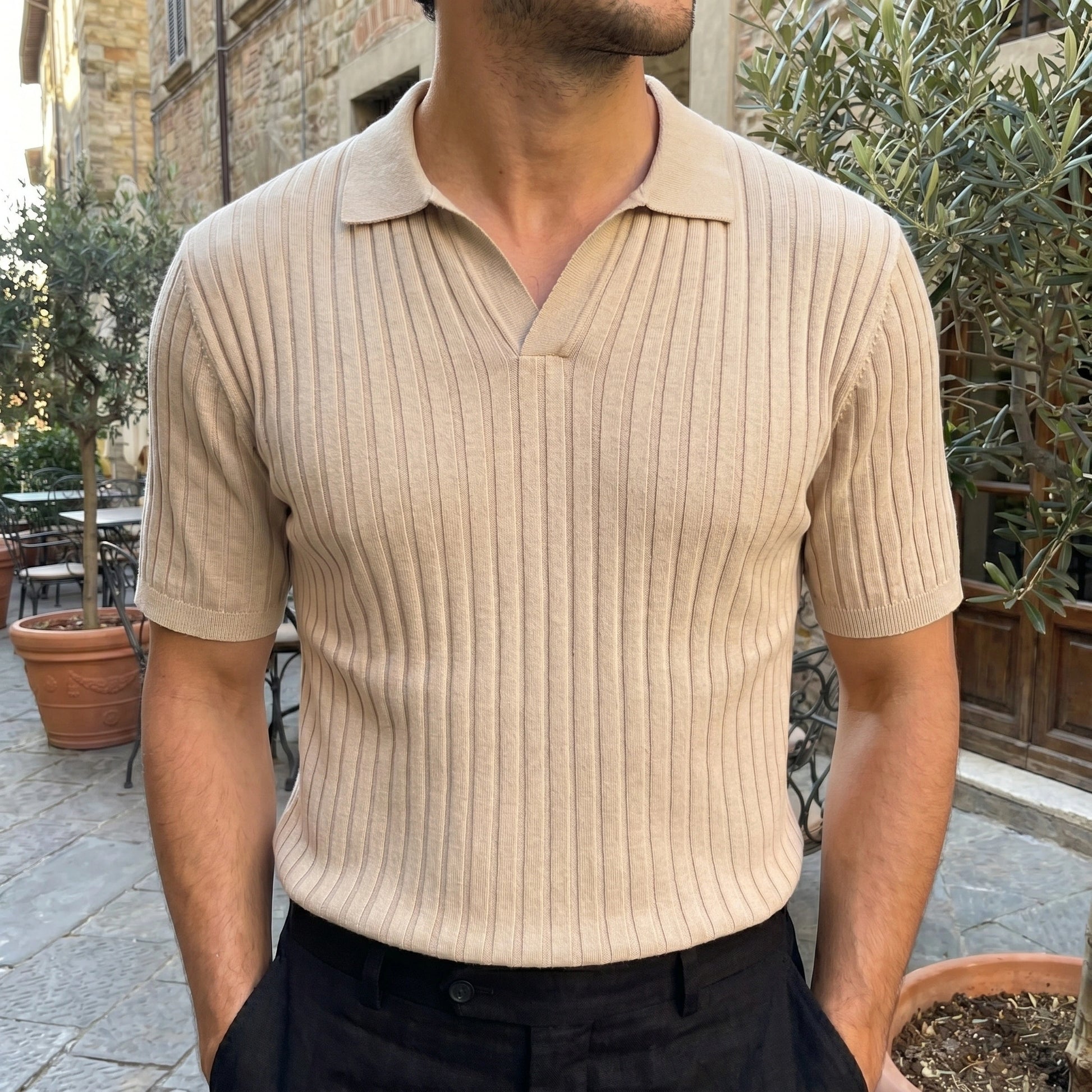 Close up of the men's versatile summer polo shirt showing the fine stitching, soft fabric texture, and colorful against a neutral background.