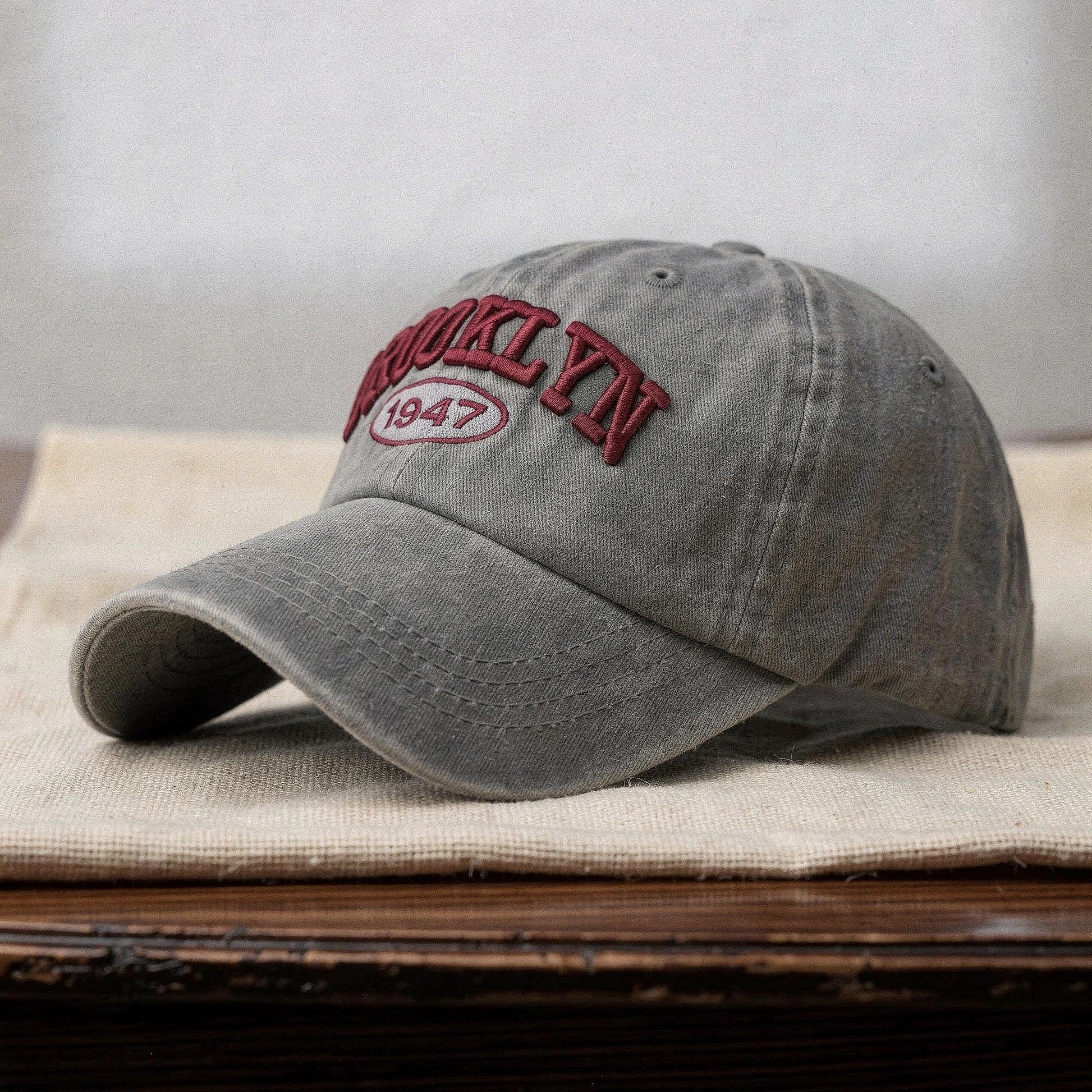 View of a navy blue embroidered cap with a casual chic design, featuring a curved brim and adjustable strap