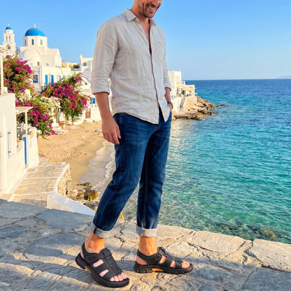 Back view of men's durable summer sandals showing their construction details, showing a sleek design in earthy tones against a neutral background.