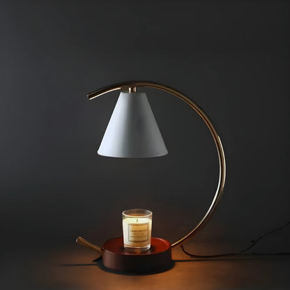 View of a sculptural dimmable candle warmer table lamp in earthy tones with a sleek design and textured surface