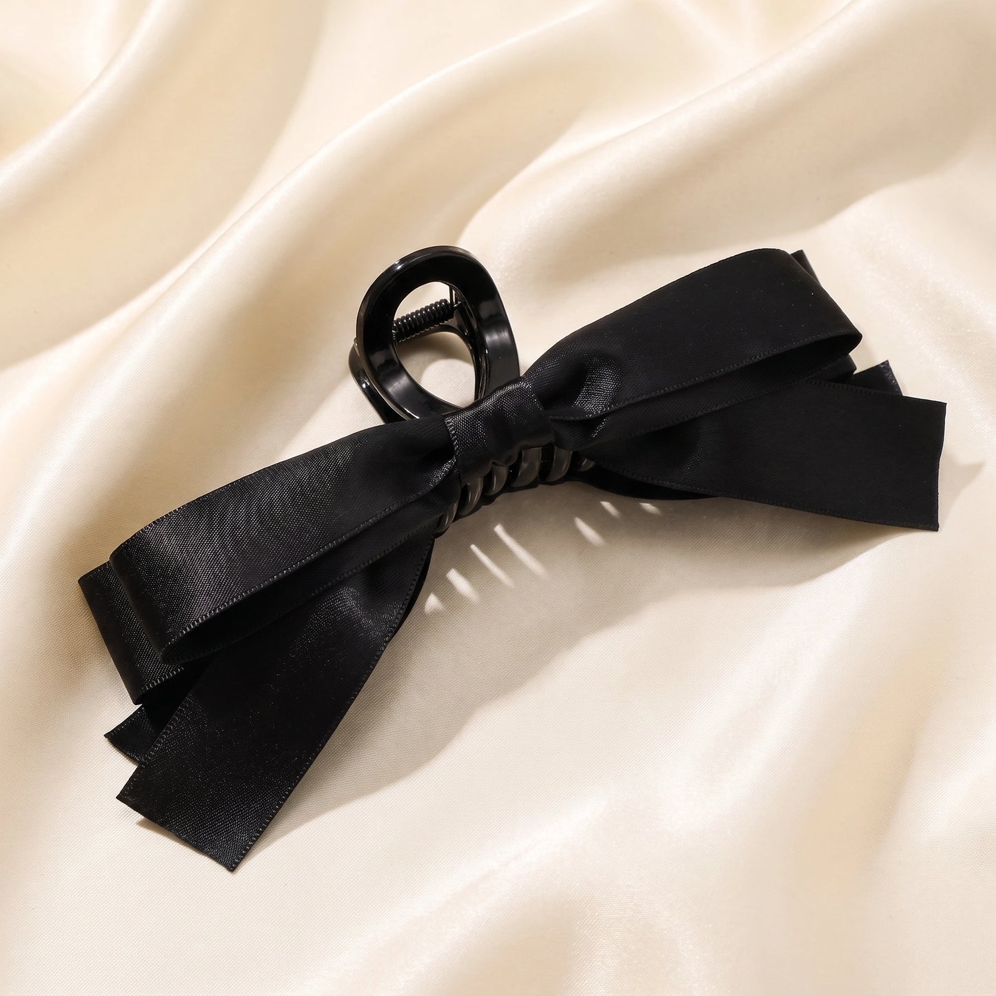 A model showcases hair clips, styled with a sophisticated outfit showing neutral tones, set against a minimalist background that enhances the overall look.