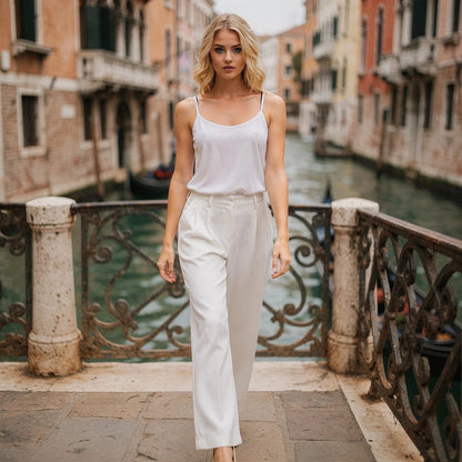 View of elegant high waisted wide leg pants in soft beige fabric, showcasing the pleated and flowing silhouette