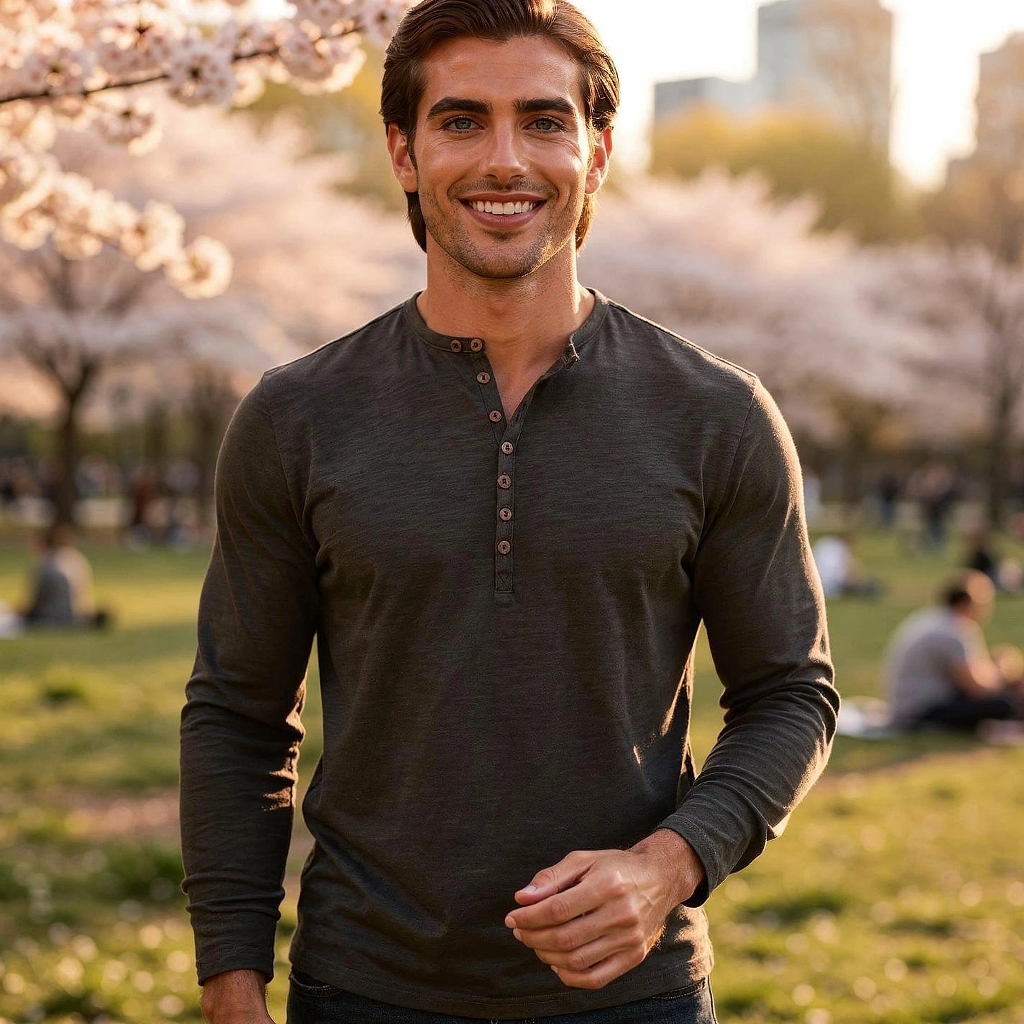 View of a light gray long sleeve henley shirt made of soft cotton, featuring a three button placket and ribbed cuffs