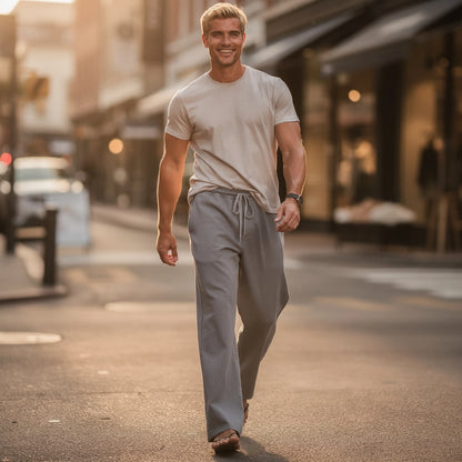View of wide loose relaxed fit trousers in soft beige fabric, featuring a comfortable waistband and pockets