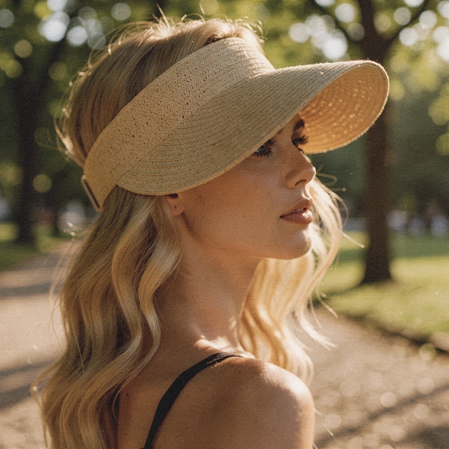 Light beige summer visor hat with a wide brim and stylish woven texture, detailed view showcasing the material and stitching