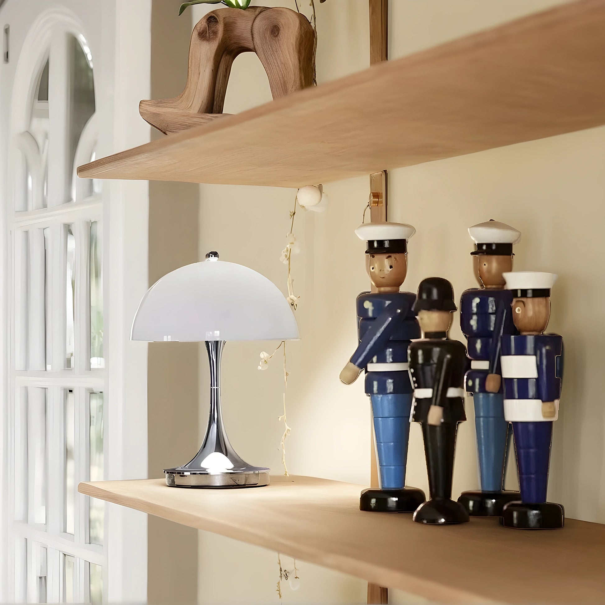 View of a sleek contemporary rechargeable table lamp in a warm metallic finish, featuring a minimalist design and soft light