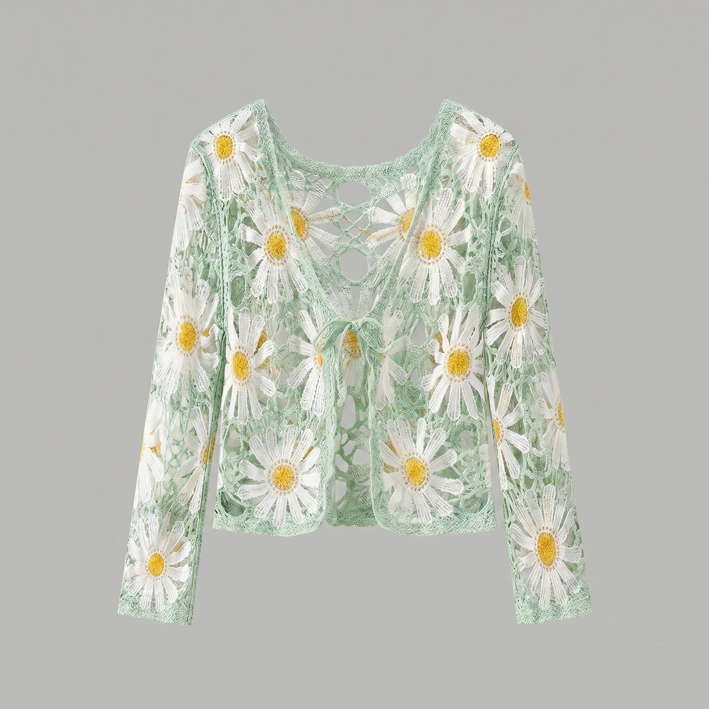 A model showcases a lightweight sheer boho summer cardigan in Light Green, styled with high waisted shorts against a bright beach backdrop.