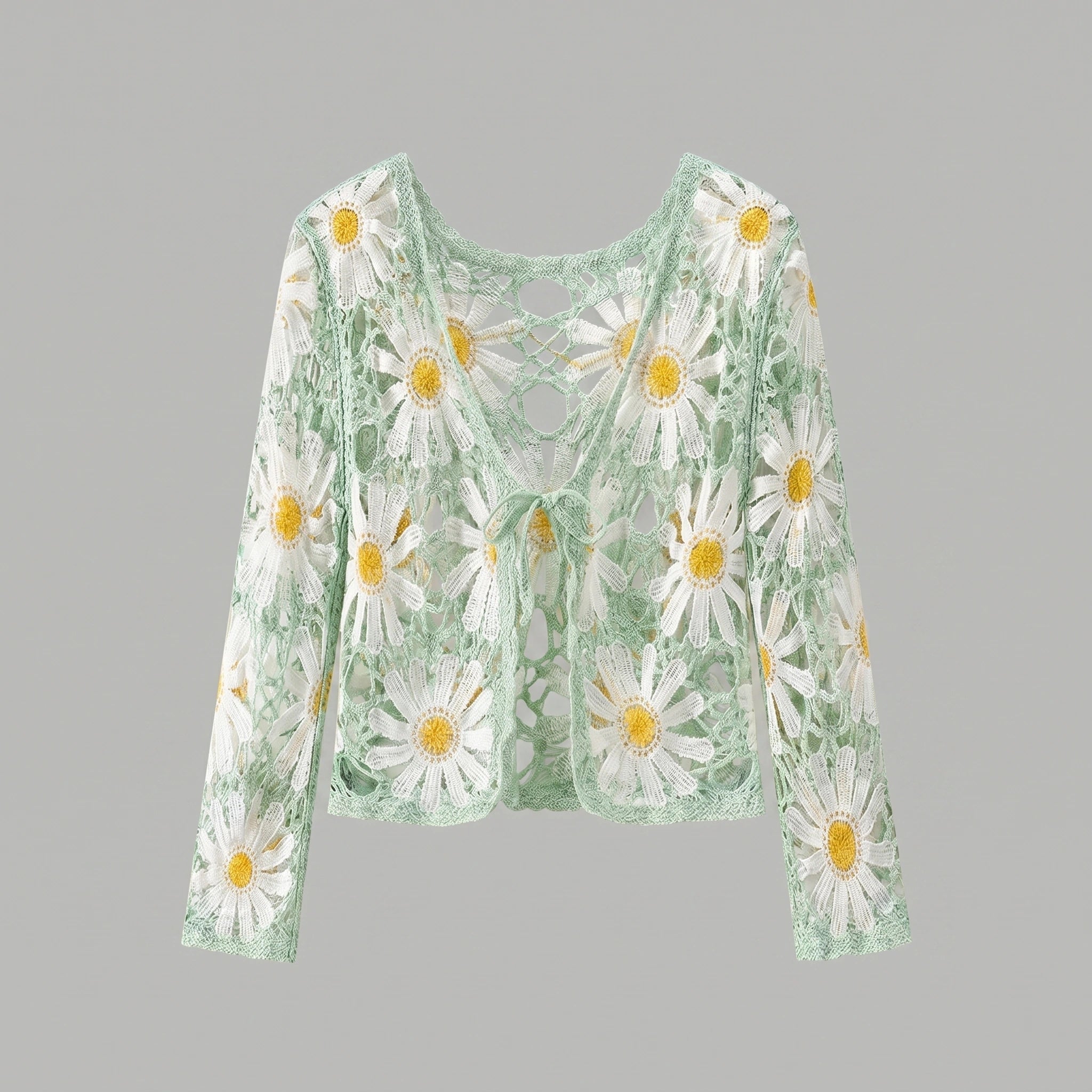 A model showcases a lightweight sheer boho summer cardigan in Light Green, styled with high waisted shorts against a bright beach backdrop.