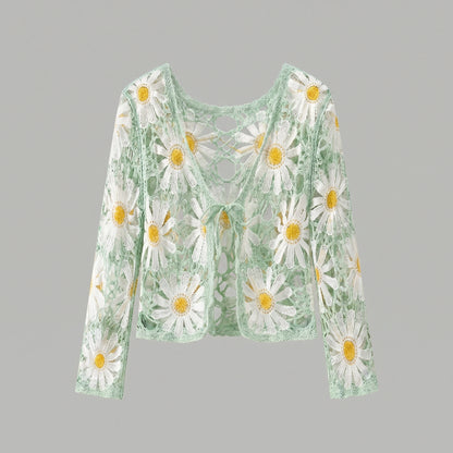 A model showcases a lightweight sheer boho summer cardigan in Light Green, styled with high waisted shorts against a bright beach backdrop.