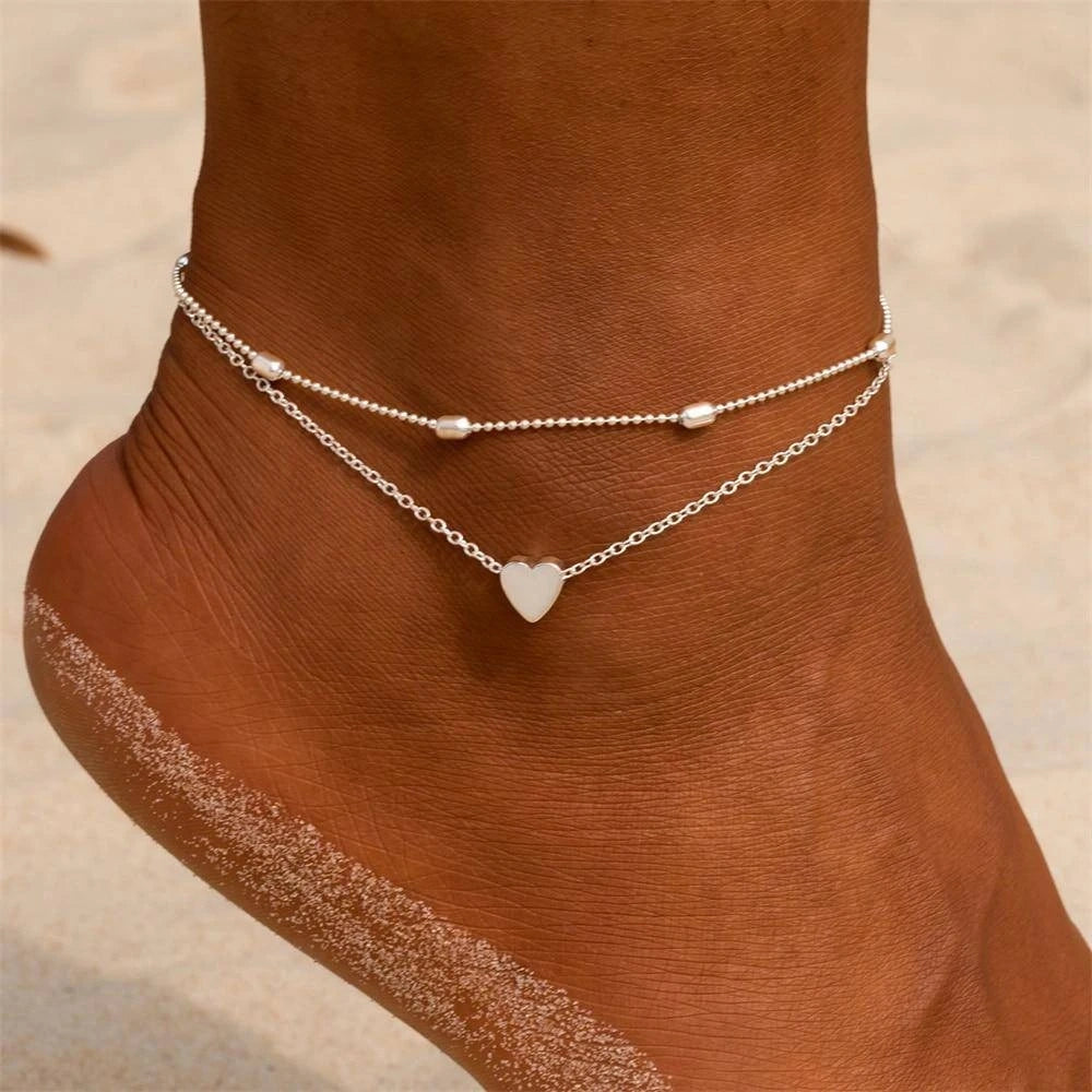 A model showcases the Womens Romantic Anklet, paired with a outfit showing soft pastel colors, set against a neutral background.