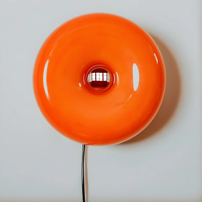 View of a sleek modern glass donut table lamp, featuring an adjustable lighting design with a clear glass base
