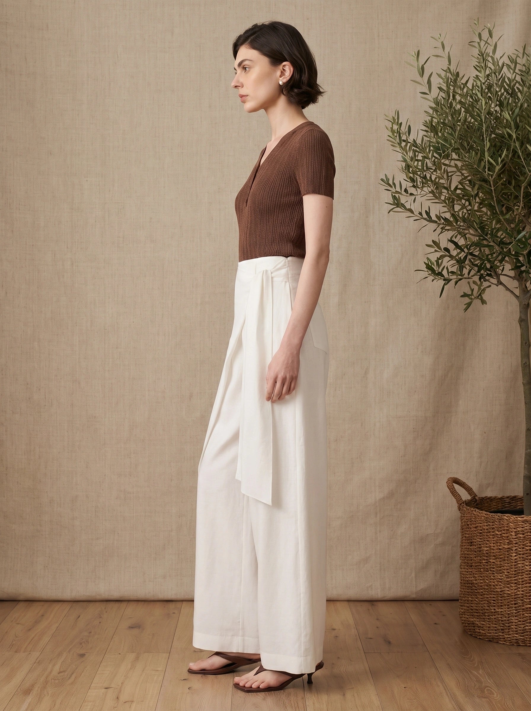 Back view of the Womens Effortless Summer Pants in Off White, showing the high waisted design and tailoring against a neutral backdrop.