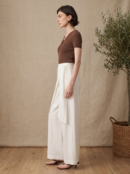 Back view of the Womens Effortless Summer Pants in Off White, showing the high waisted design and tailoring against a neutral backdrop.
