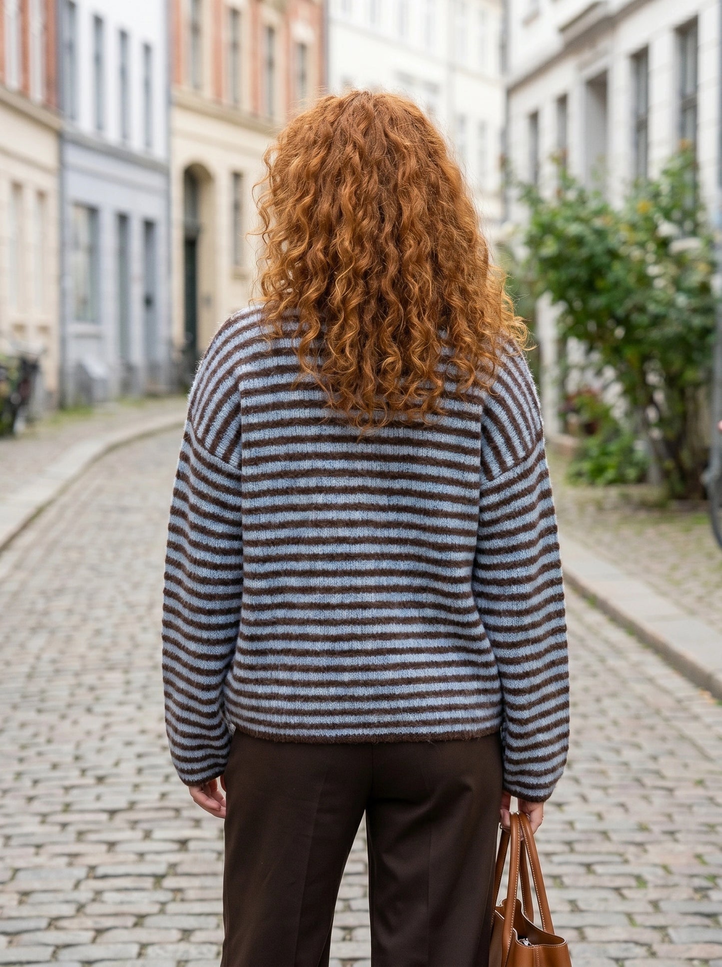 Close up of the Womens Relaxed Striped Autumn Cardigan showing the soft fabric texture and intricate stitching in warm autumn hues.