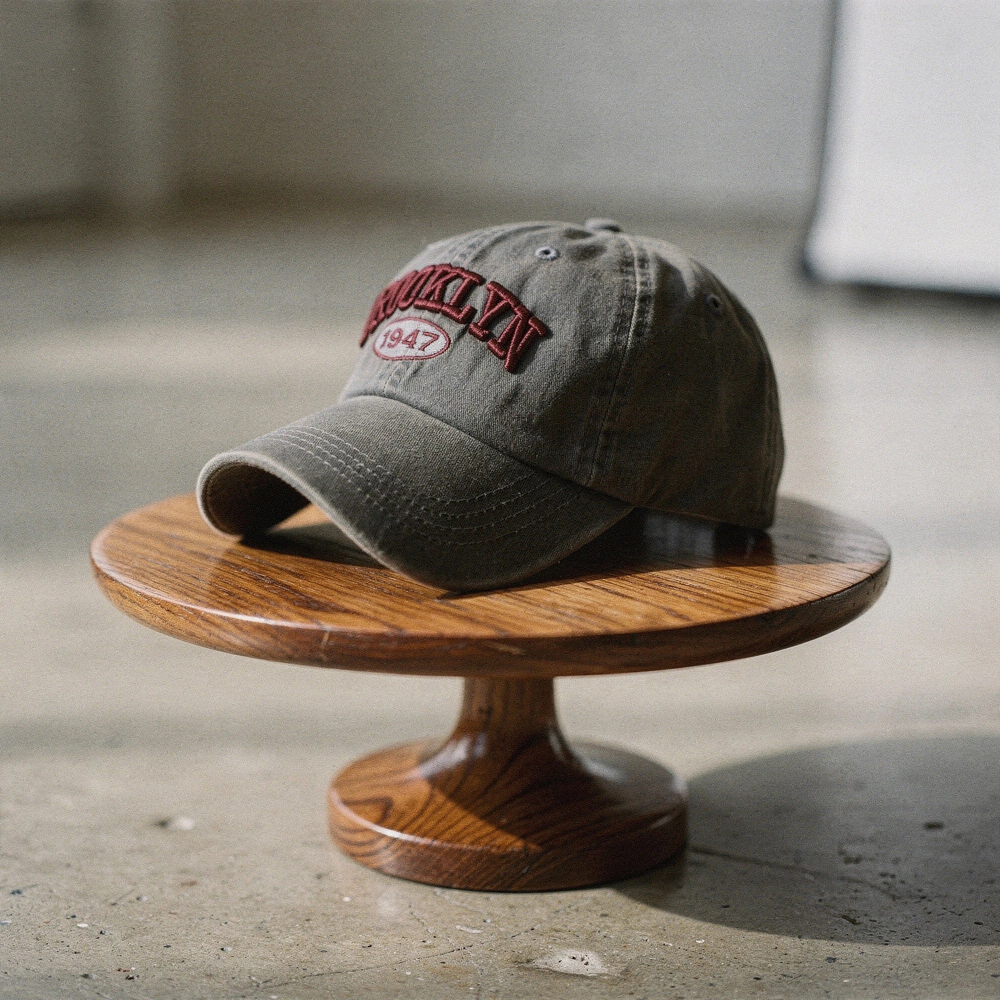View of a navy blue embroidered cap featuring a casual chic design and adjustable strap at the