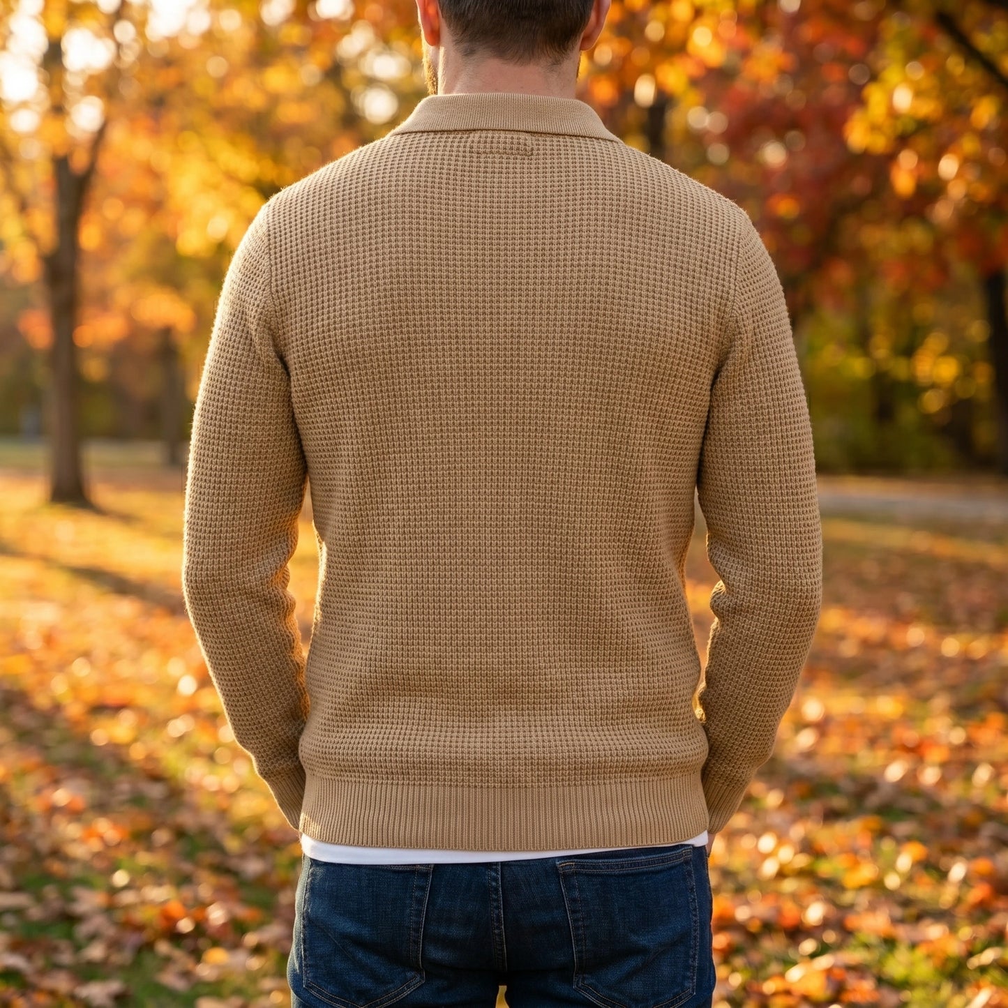 Close up view of the Mens Sophisticated Knit Polo Sweater showing intricate stitching and luxurious fabric texture against a neutral background.