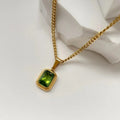 View of a vintage necklace featuring a delicate chain and a central peridot gemstone, showcasing its refined design and elegant color