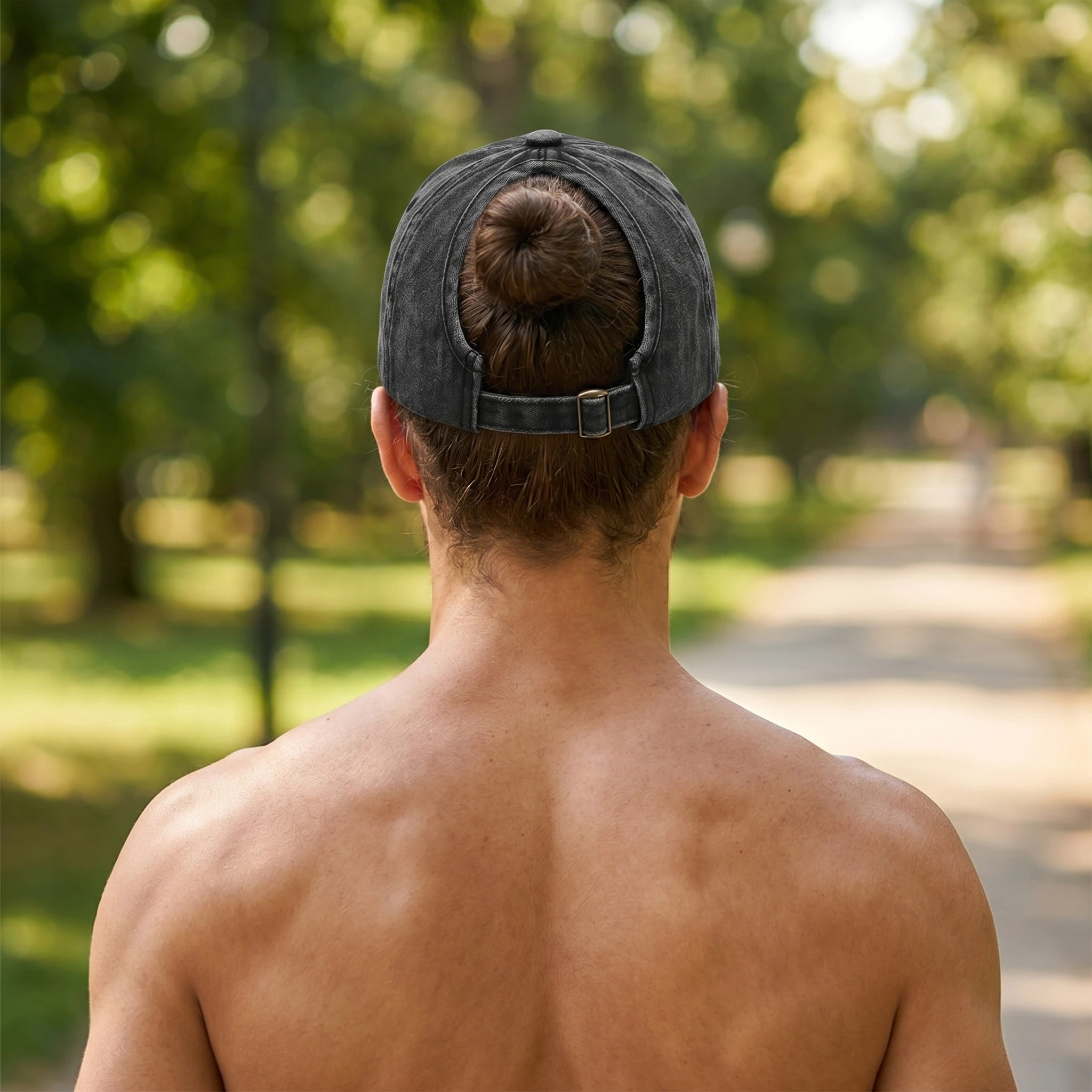 Back view of a washed cotton baseball cap showing its soft fabric and construction details, set against a natural outdoor background.