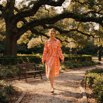 View of a women's wrap dress featuring a vibrant floral print in shades of blue and pink, with a flattering silhouette