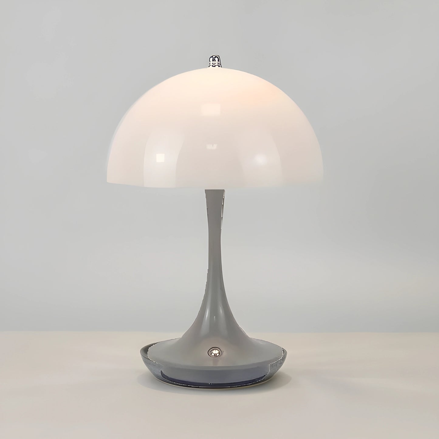 View of a sleek contemporary rechargeable table lamp in a warm metallic finish, featuring a minimalist design and soft light