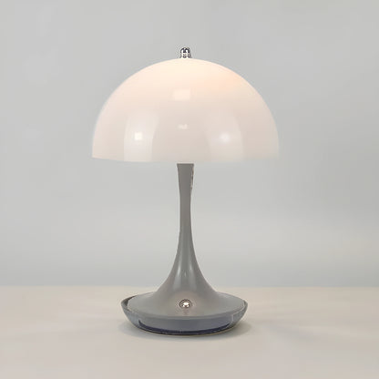 View of a sleek contemporary rechargeable table lamp in a warm metallic finish, featuring a minimalist design and soft light