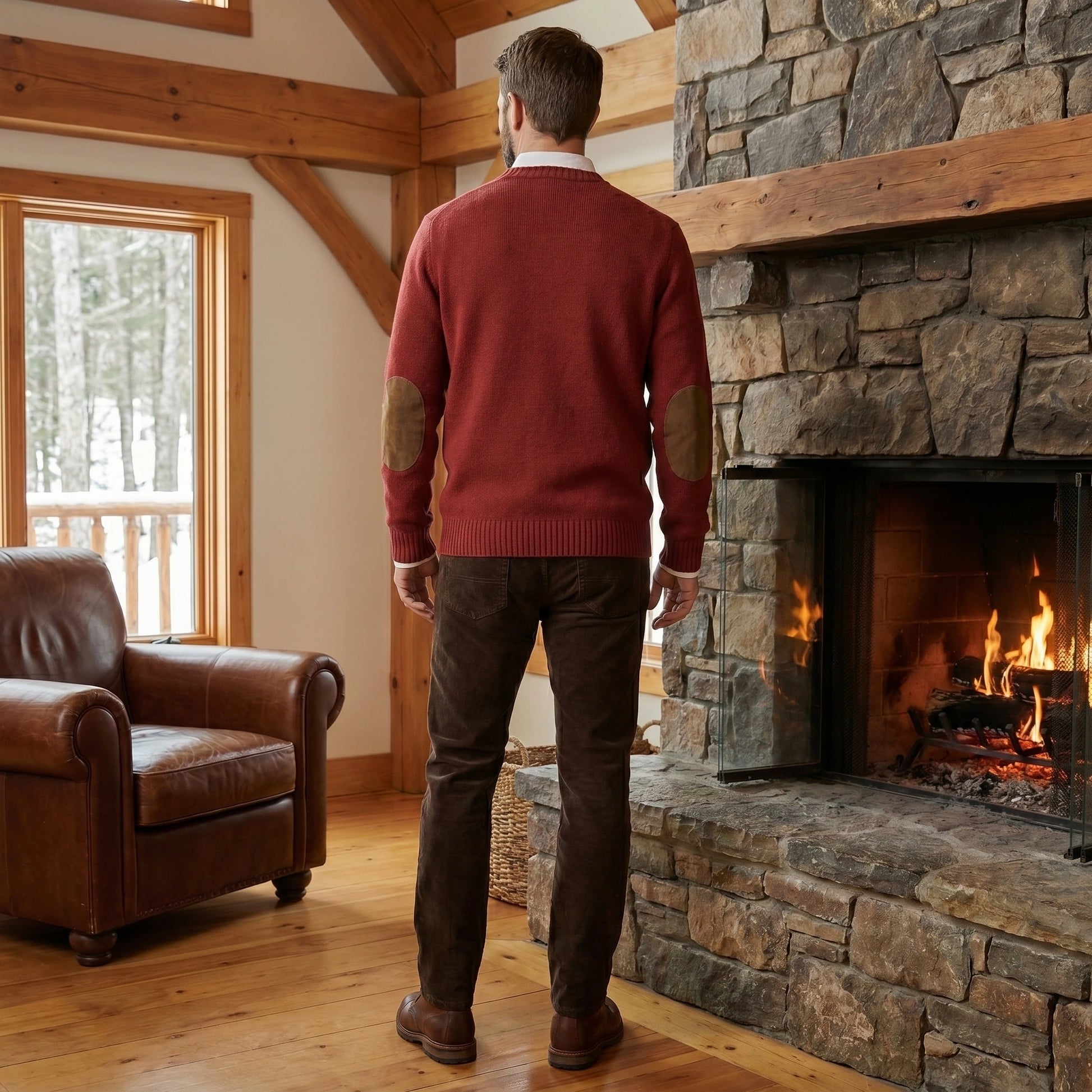Close up of the Mens Timeless Relaxed Sweater showing the soft fabric texture and detailed stitching, showing its elbow patches against a neutral background.