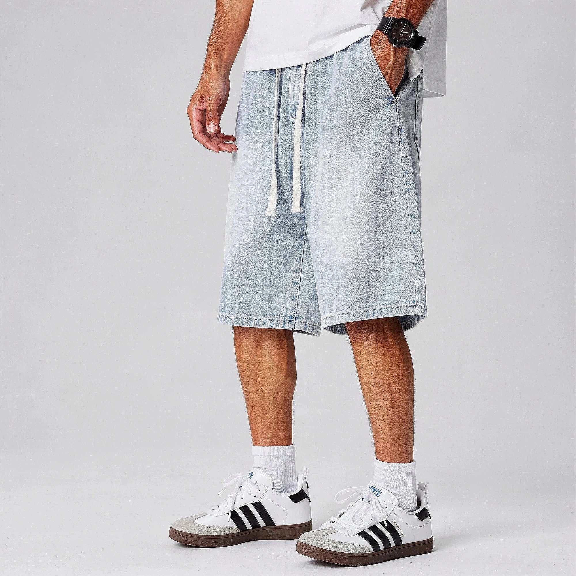 View of relaxed fit denim shorts in light blue, featuring an elastic waistband and pockets