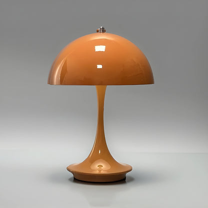 View of a sleek contemporary rechargeable table lamp in a warm gold finish, showcasing its elegant base and soft white shade