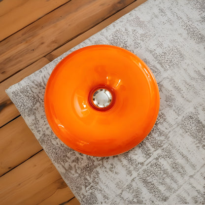 Sleek modern glass donut table lamp in a view, featuring an adjustable lighting design and a minimalist aesthetic
