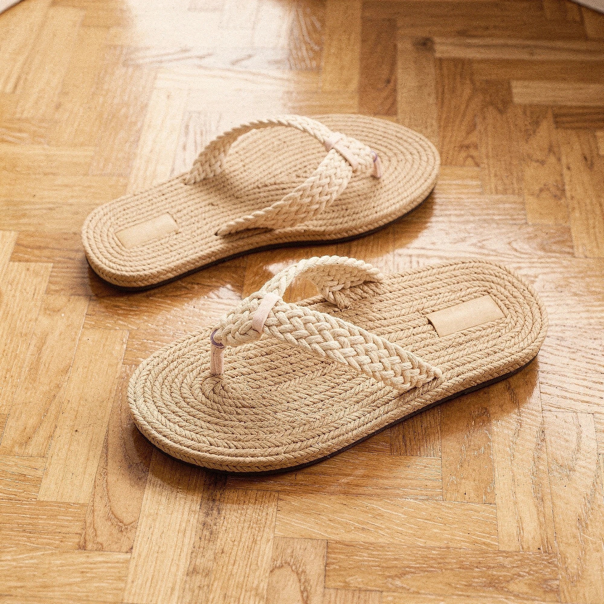 View of relaxed textured imitation hemp flip flops in natural beige with a comfortable sole and adjustable straps