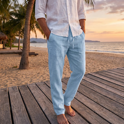 Close up of the lightweight summer linen fabric showing fine stitching and a relaxed fit, showing the trousers' breathable texture and design.