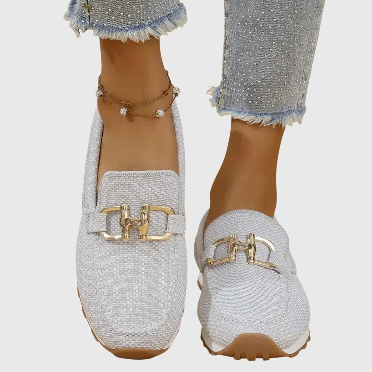 View of elegant women's casual loafers in soft beige leather with breathable perforations and a comfortable slip on design