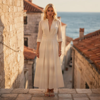 View of a flowing midi dress in soft fabric, featuring a button and a relaxed fit in a light pastel color