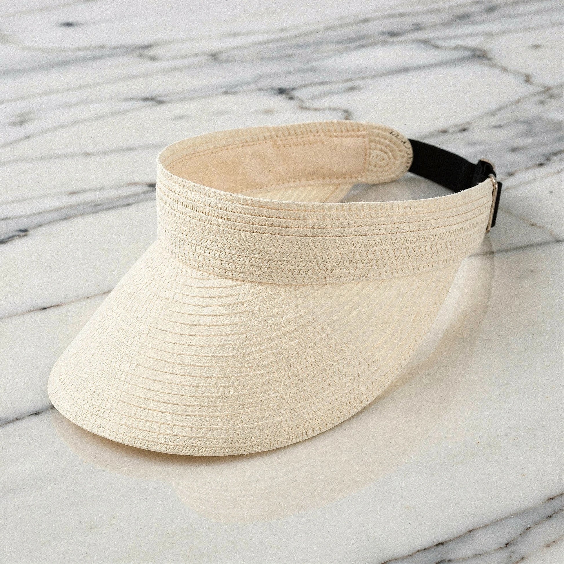 Lightweight straw visor hat in beige with a wide brim and a stylish bow , view