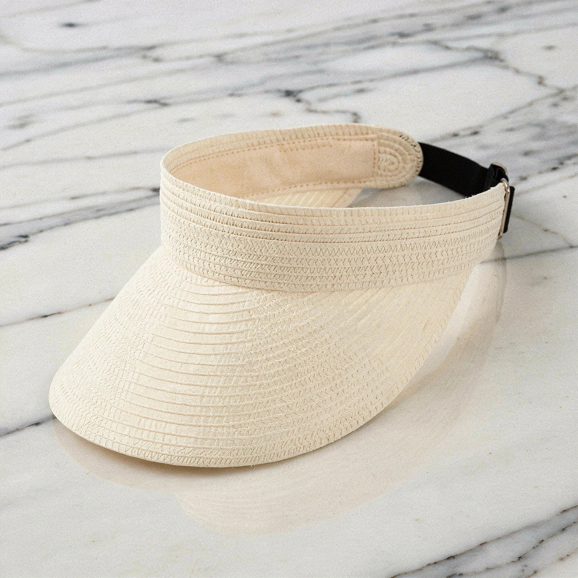 Lightweight straw visor hat in beige with a wide brim and a stylish bow , view