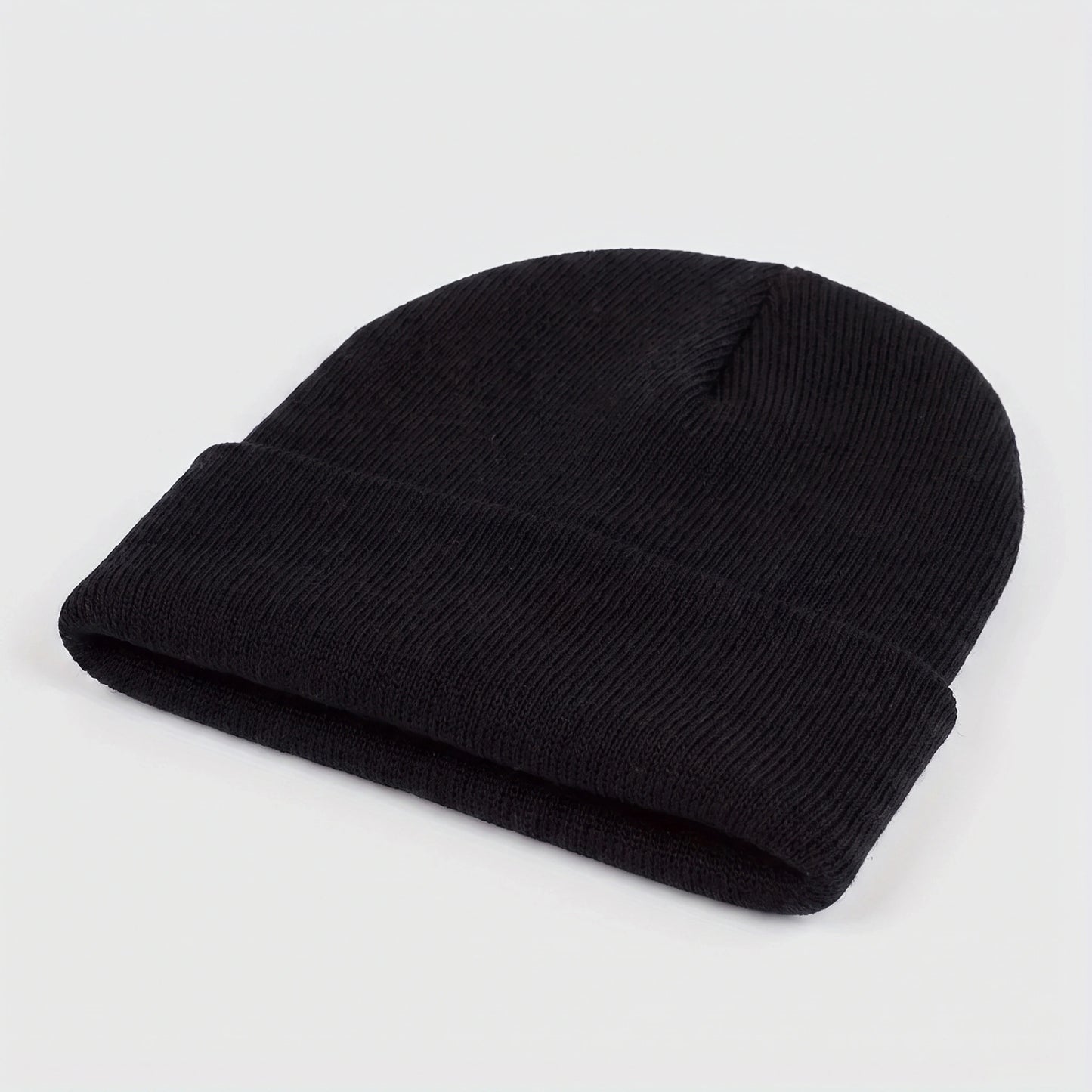 A model showcases the Mens Casual Warm Winter Beanie in a cozy outfit, showing neutral tones against a soft outdoor backdrop, perfect for winter adventures.
