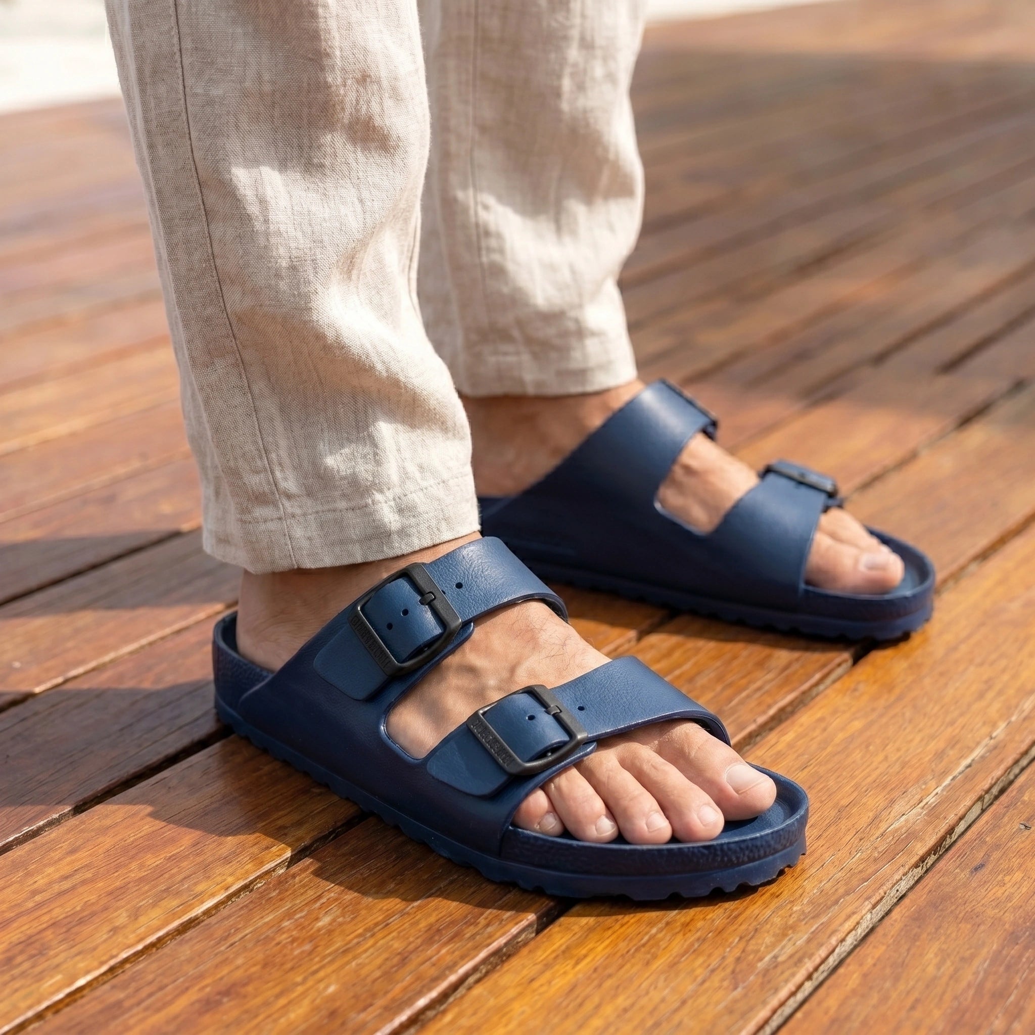Close up view of the lightweight fabric and detailed stitching of men's casual summer slides, showing their comfort and design against a neutral background.
