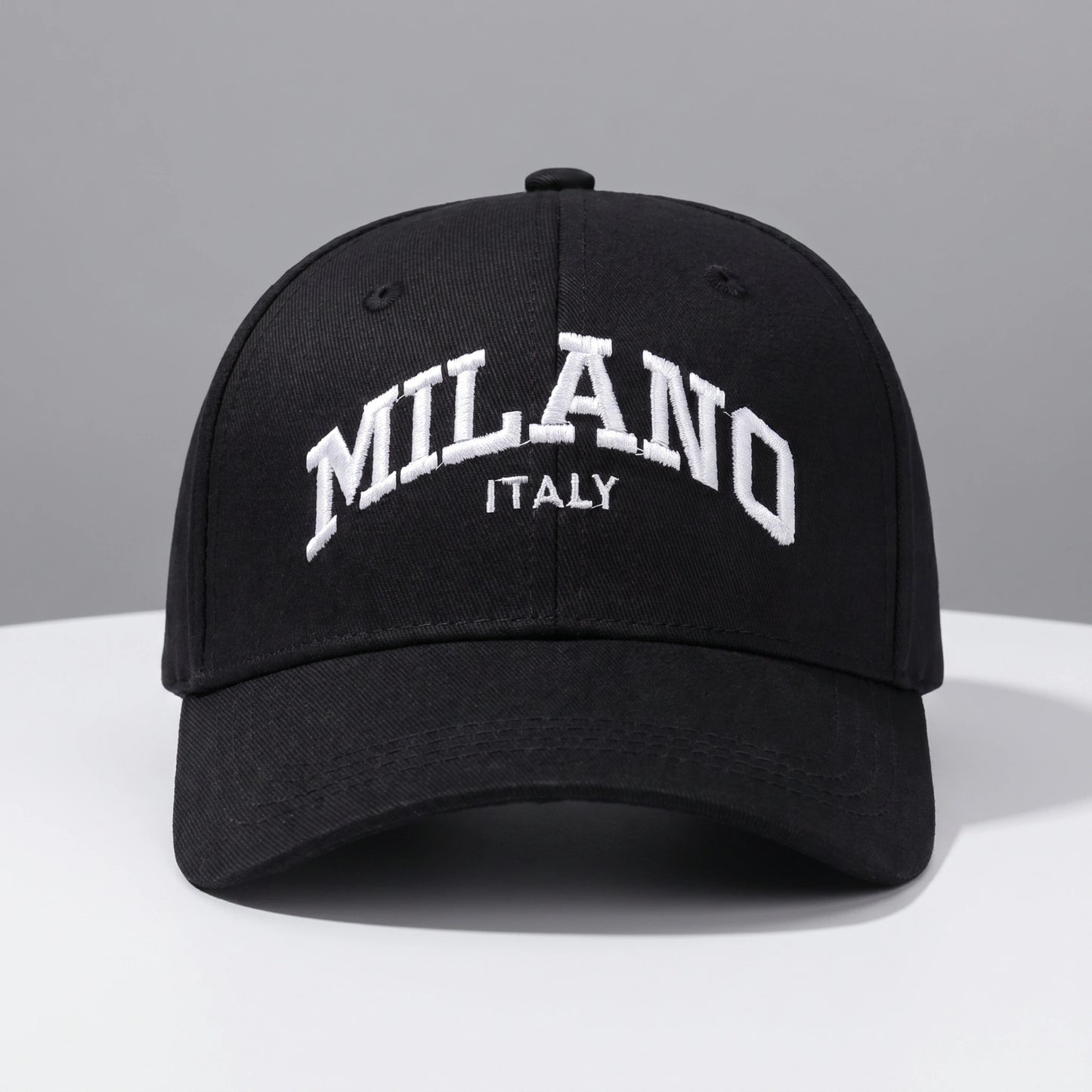 Back view of a adjustable embroidered baseball cap showing its durable construction and design, set against a neutral outdoor background.