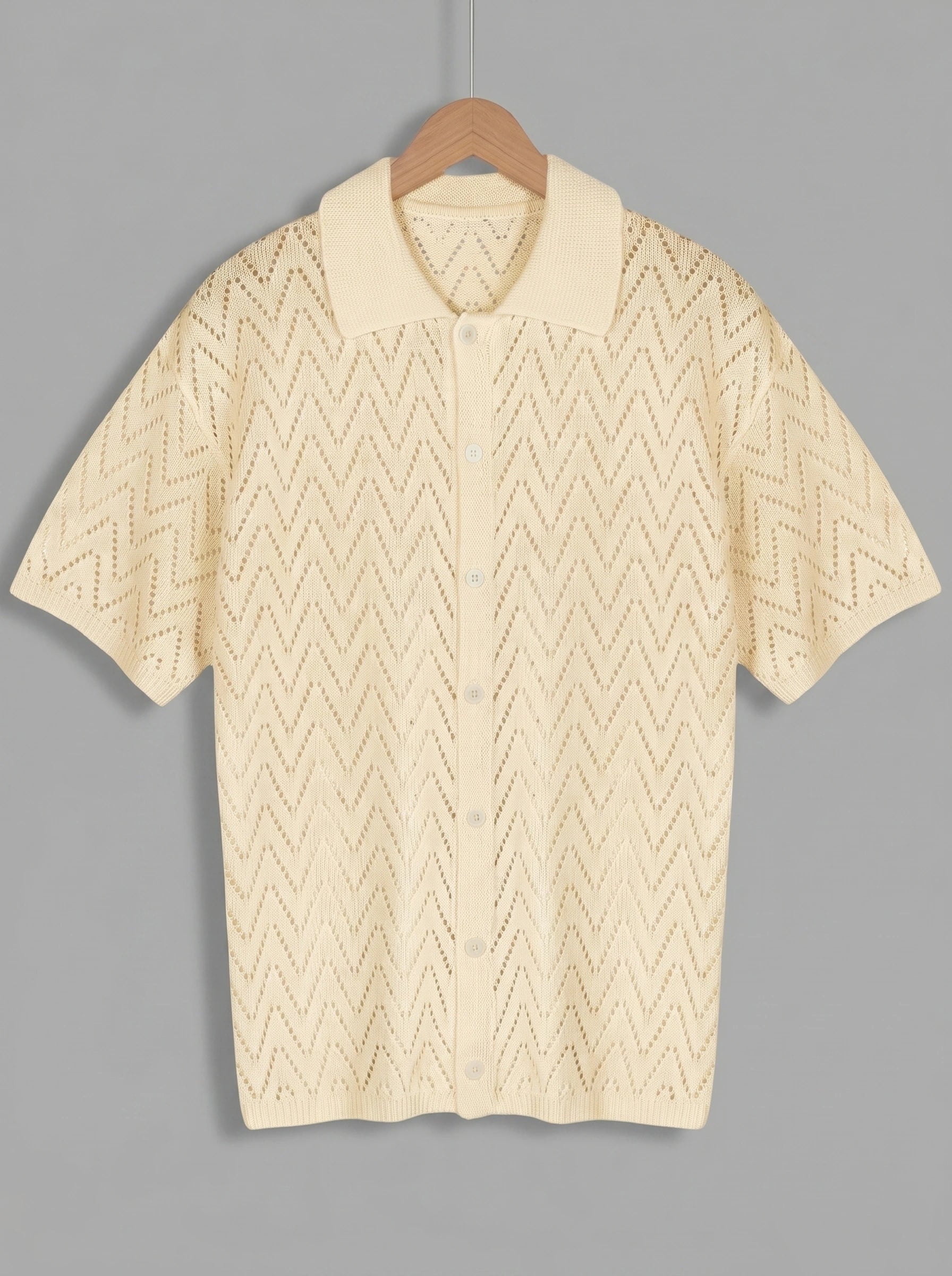 Close up view of the soft, breathable fabric and precise stitching of the men's relaxed summer knit shirt in a 01 Apricot, showing its quality and design.