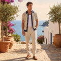 A male model showcases a slim summer knit shirt in a soft blue hue, styled with casual shorts against a light, neutral background.